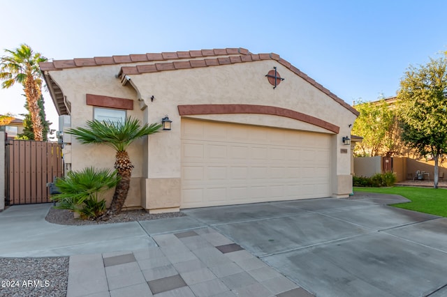 mediterranean / spanish-style house with a garage