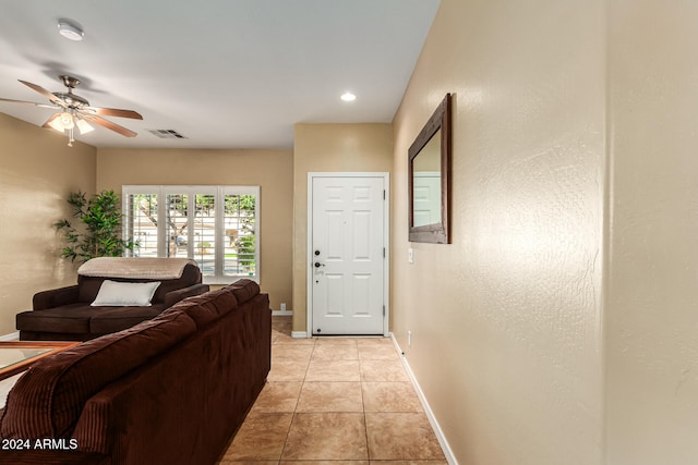 tiled living room with ceiling fan