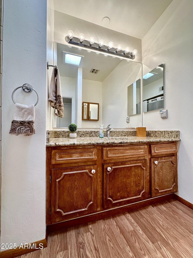 bathroom with vanity and hardwood / wood-style floors