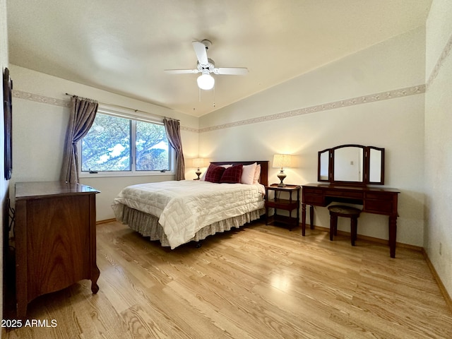 bedroom featuring vaulted ceiling, ceiling fan, and light hardwood / wood-style flooring