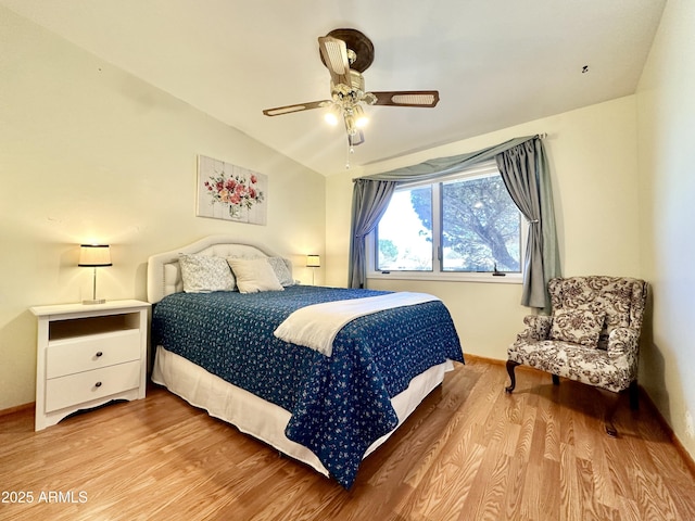 bedroom featuring lofted ceiling, hardwood / wood-style floors, and ceiling fan