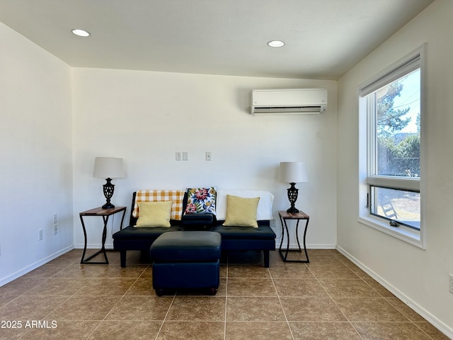 sitting room with tile patterned floors and an AC wall unit