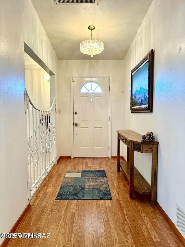 entrance foyer featuring an inviting chandelier and light wood-type flooring