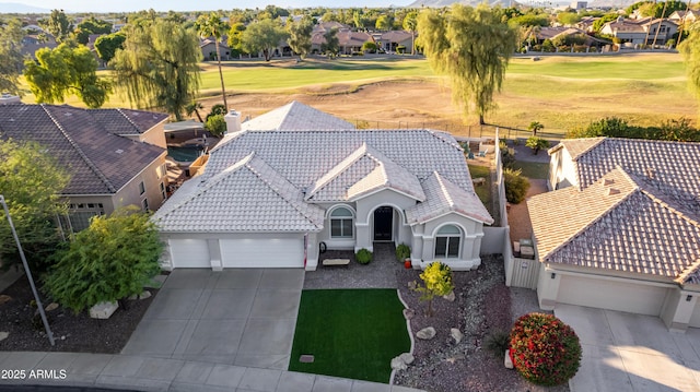 drone / aerial view featuring view of golf course and a residential view