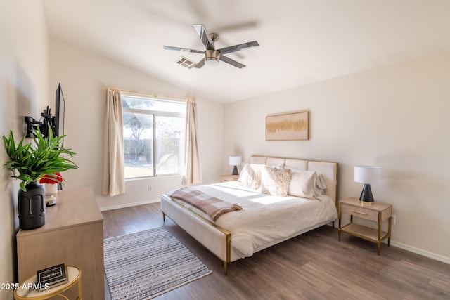 bedroom with ceiling fan, dark wood-type flooring, and lofted ceiling