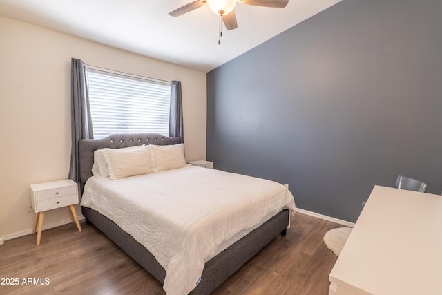 bedroom with dark wood-type flooring and ceiling fan