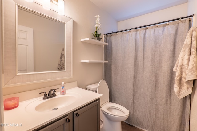 bathroom with vanity, toilet, and walk in shower