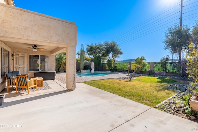 view of yard with ceiling fan, a fenced in pool, and a patio