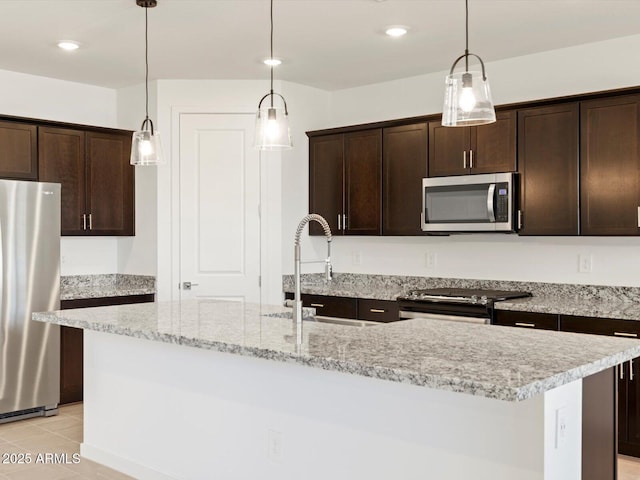 kitchen with a center island with sink, appliances with stainless steel finishes, and sink