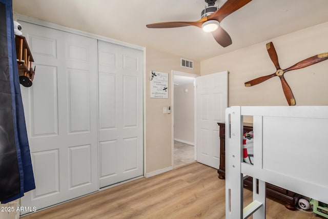 2256 S Las Flores, Mesa, AZ 85202 - bedroom featuring light wood finished floors, a closet, a ceiling fan, and baseboards