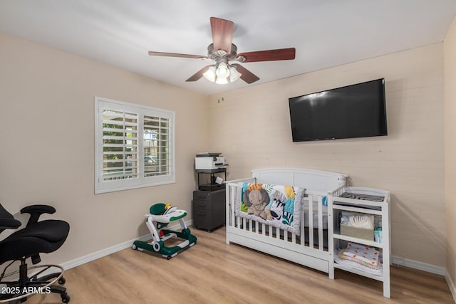 2256 S Las Flores, Mesa, AZ 85202 - bedroom with wood finished floors, baseboards, a ceiling fan, and a nursery area