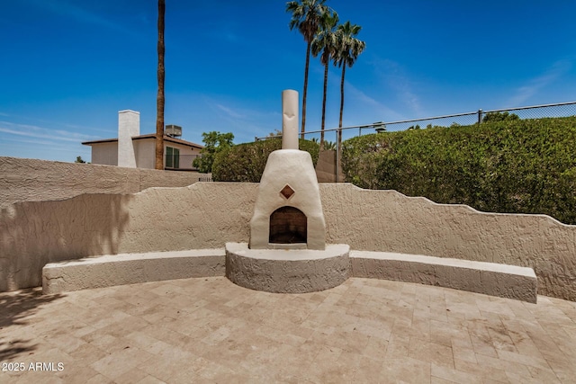 2256 S Las Flores, Mesa, AZ 85202 - fenced backyard featuring an outdoor fireplace and a patio area