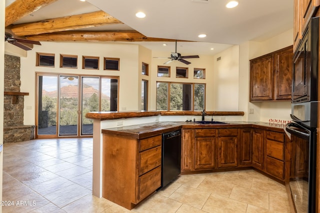 kitchen with sink, ceiling fan, beam ceiling, black dishwasher, and kitchen peninsula