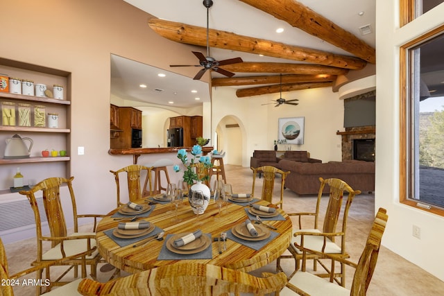 carpeted dining room featuring beam ceiling and ceiling fan