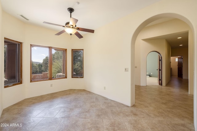 spare room with light tile patterned flooring and ceiling fan