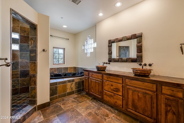 bathroom featuring vanity and shower with separate bathtub