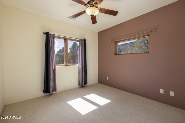 empty room featuring carpet floors and ceiling fan