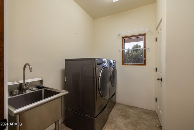 washroom with sink and washing machine and clothes dryer