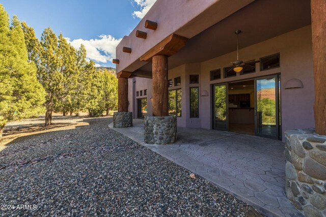 exterior space with ceiling fan