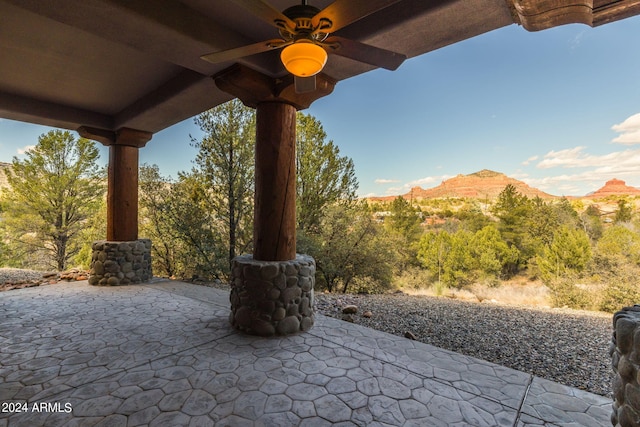 view of patio featuring a mountain view and ceiling fan