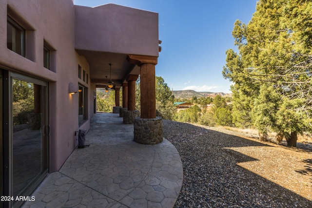 view of patio / terrace featuring a mountain view and ceiling fan