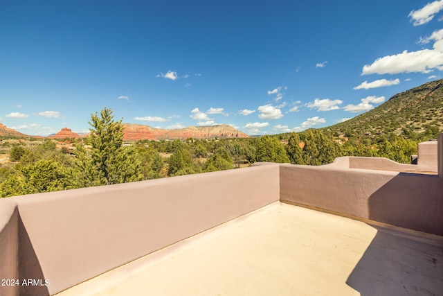 view of patio / terrace featuring a balcony and a mountain view