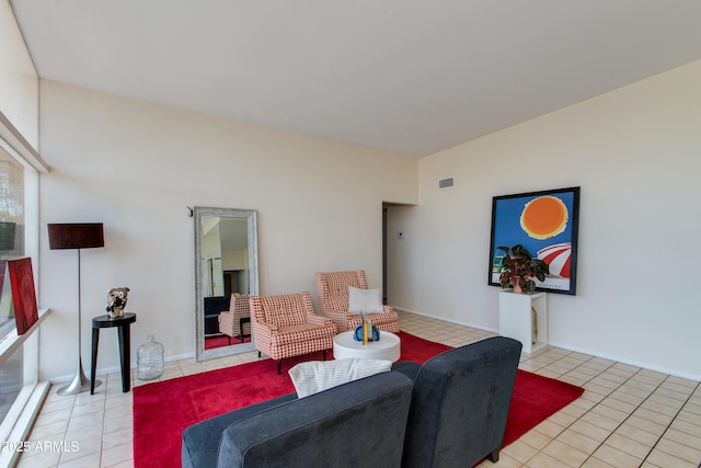 living room featuring light tile patterned floors and visible vents