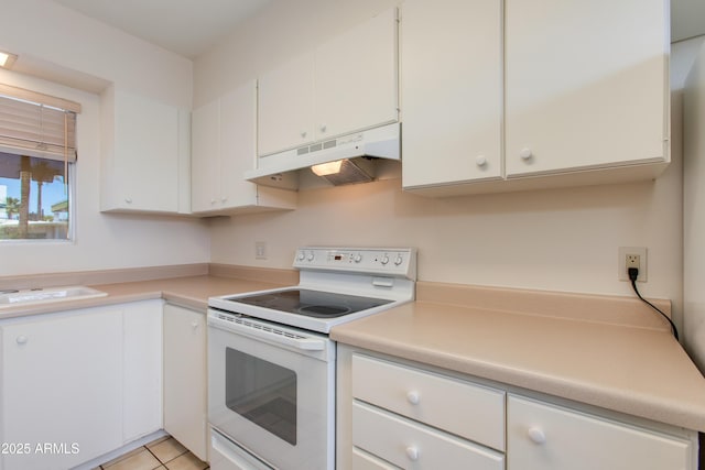kitchen featuring white range with electric cooktop, light countertops, white cabinets, and under cabinet range hood
