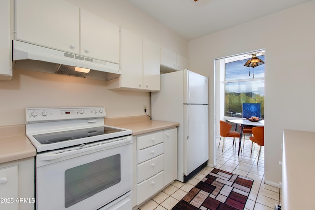 kitchen with light tile patterned floors, white cabinetry, light countertops, under cabinet range hood, and white appliances