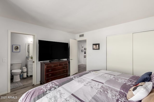 1401 E Puget Ave Unit 4, Phoenix, AZ 85020 - bedroom with wood finished floors, a closet, and ensuite bath