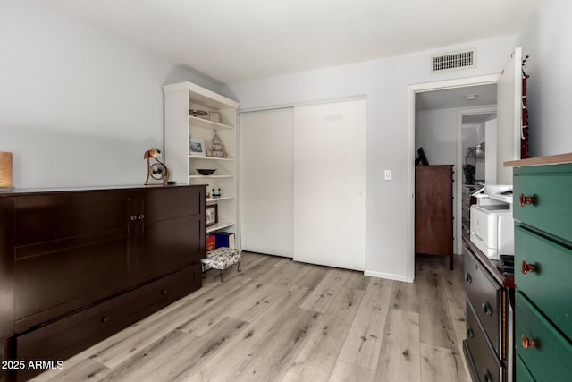 1401 E Puget Ave Unit 4, Phoenix, AZ 85020 - bedroom with light wood-type flooring and a closet