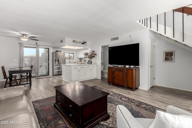 1401 E Puget Ave Unit 4, Phoenix, AZ 85020 - living area with light wood finished floors, a ceiling fan, and baseboards