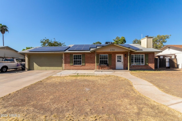 ranch-style home with a garage, brick siding, driveway, and fence