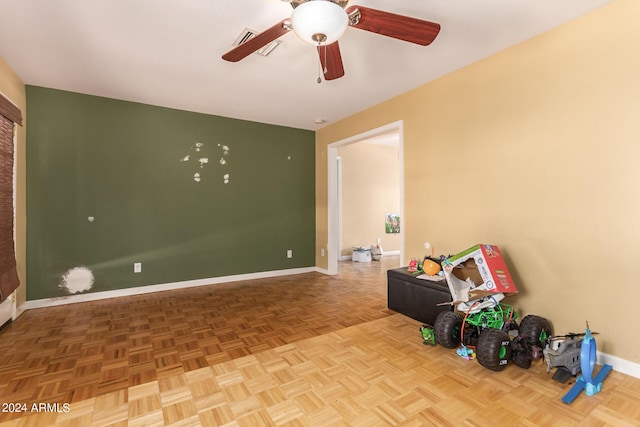 unfurnished room featuring a ceiling fan, visible vents, and baseboards