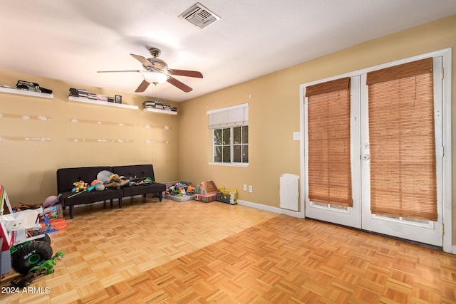 game room with ceiling fan, visible vents, and baseboards