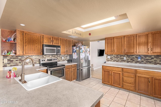 kitchen featuring appliances with stainless steel finishes, a raised ceiling, a sink, and open shelves