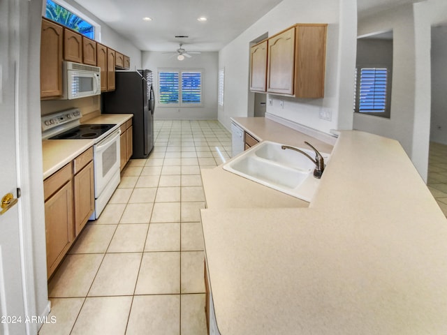 kitchen with ceiling fan, white appliances, sink, and light tile flooring