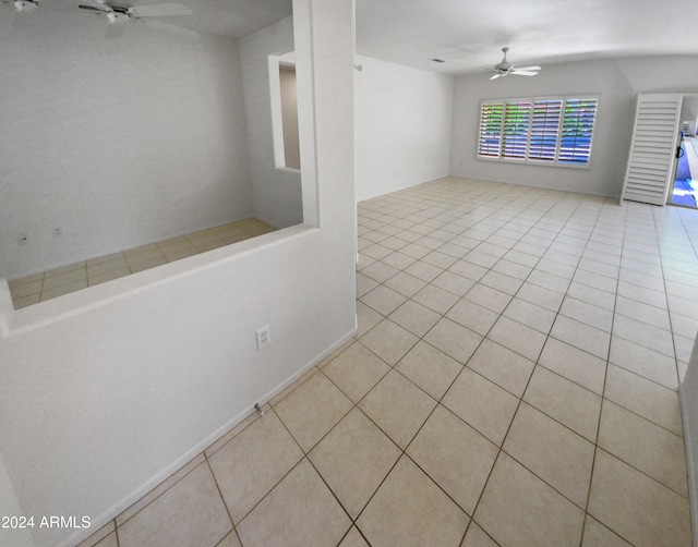 tiled spare room featuring ceiling fan