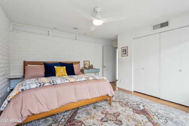 110 W Missouri Ave Unit 18, Phoenix, AZ 85013 - bedroom with a closet, brick wall, and ceiling fan