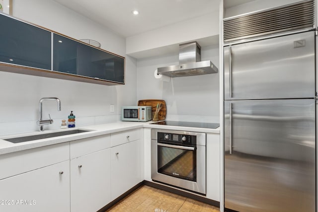 110 W Missouri Ave Unit 18, Phoenix, AZ 85013 - kitchen with stainless steel appliances, wall chimney range hood, a sink, white cabinets, and light countertops