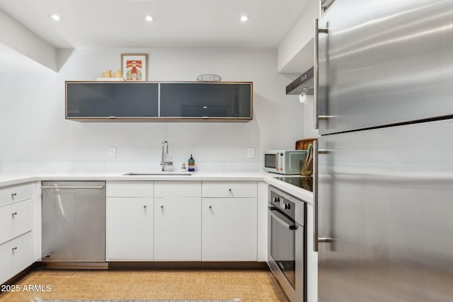 110 W Missouri Ave Unit 18, Phoenix, AZ 85013 - kitchen with stainless steel appliances, a sink, white cabinets, recessed lighting, and light countertops