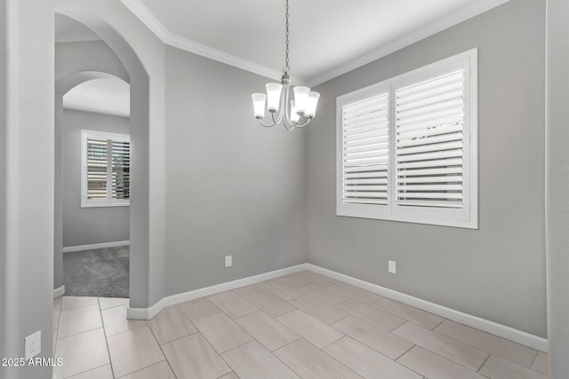 empty room featuring crown molding, light tile patterned flooring, and a chandelier