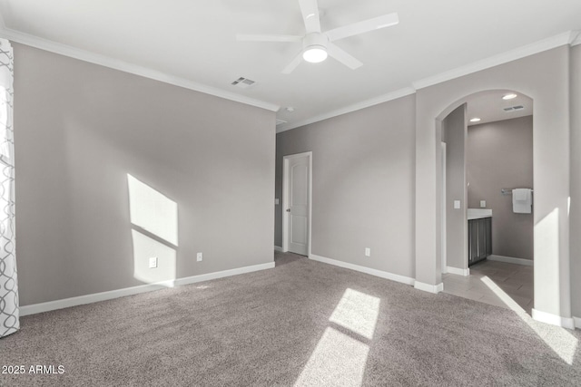 spare room with crown molding, light carpet, and ceiling fan