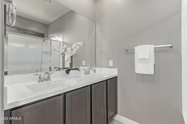 bathroom featuring vanity and an enclosed shower