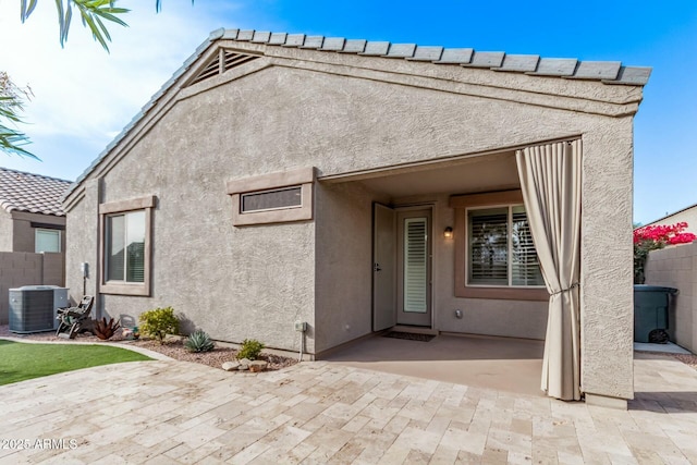 exterior space with central AC and a patio area