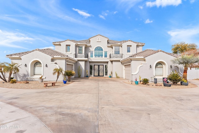 mediterranean / spanish house with a balcony and a garage