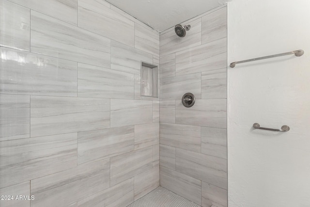 bathroom with a tile shower