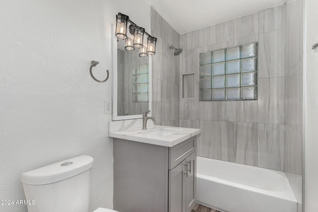 full bathroom with vanity, toilet, and tiled shower / bath combo