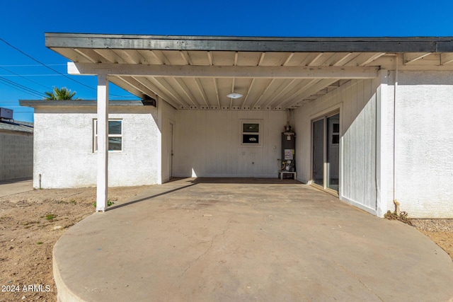 view of patio with a carport and gas water heater