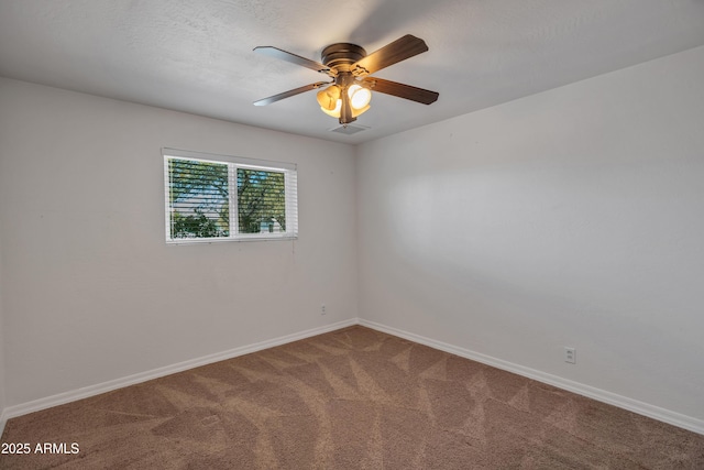 carpeted spare room with ceiling fan